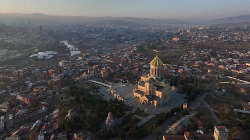 Aerial view of Holy Trinity Cathedral Sameba in Tbilisi Georgia. Winter Sunset drone footage.
