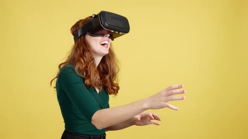 Woman Enjoys Virtual Reality Headset Experience on Yellow
