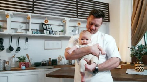 Father and Baby Cuddling in Cozy Home Kitchen