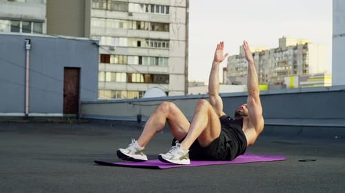 The Athlete Performs the Press Exercise Lying on His Back on the Mat