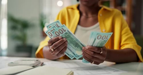 Woman, hands and counting with cash for finance, money audit or budget planning in home