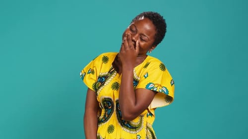Cute Female Model Giggling Against Blue Background in Studio