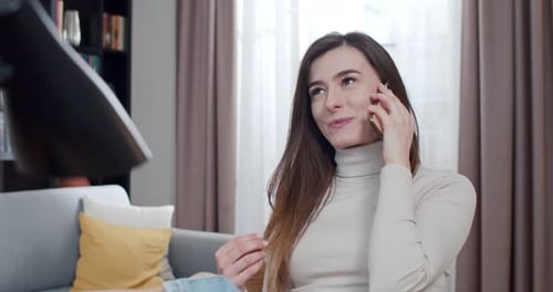 Smiling Woman Talking on Phone at Home