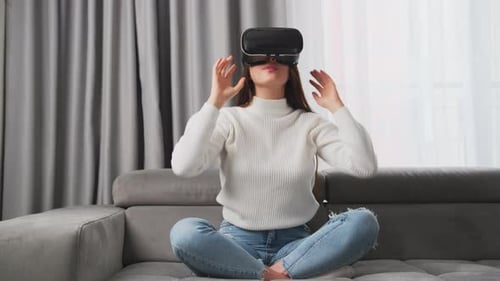 Woman Using Virtual Reality Headset at Home