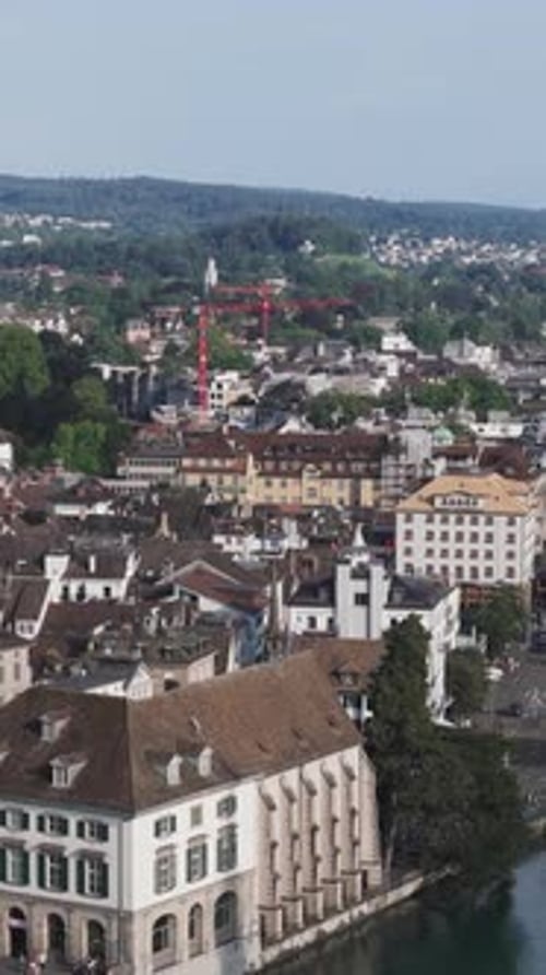 Aerial video of the Swiss flag at the Grossmunster church and the city in the background.