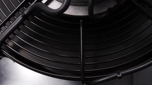 Close Up of Industrial Fan with Metal Grate