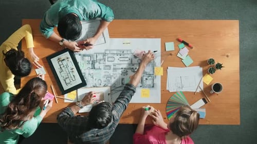 Top view of smart engineer looking at blueprint at meeting room. Symposium.