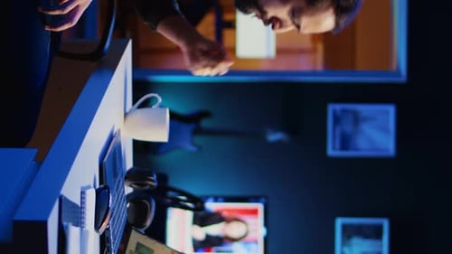 Man Working at Computer Desk Late at Night
