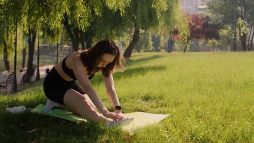 A young woman engaged in yoga in the garden. Happiness. A blurry background. Hipelly concept of life