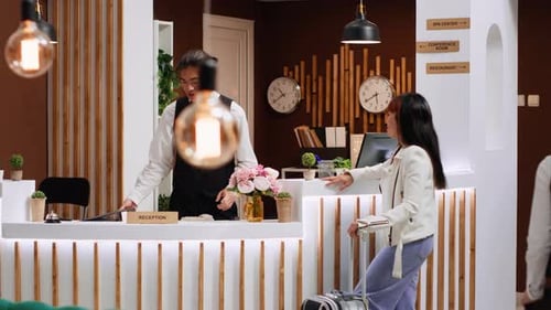 Woman Checks In at Modern Hotel Reception