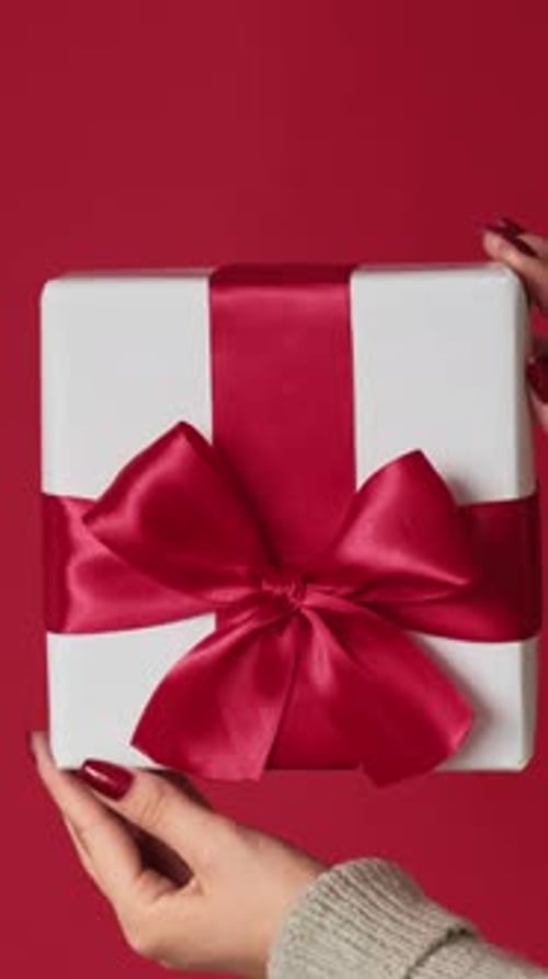 White Gift with Red Ribbon on Red Background