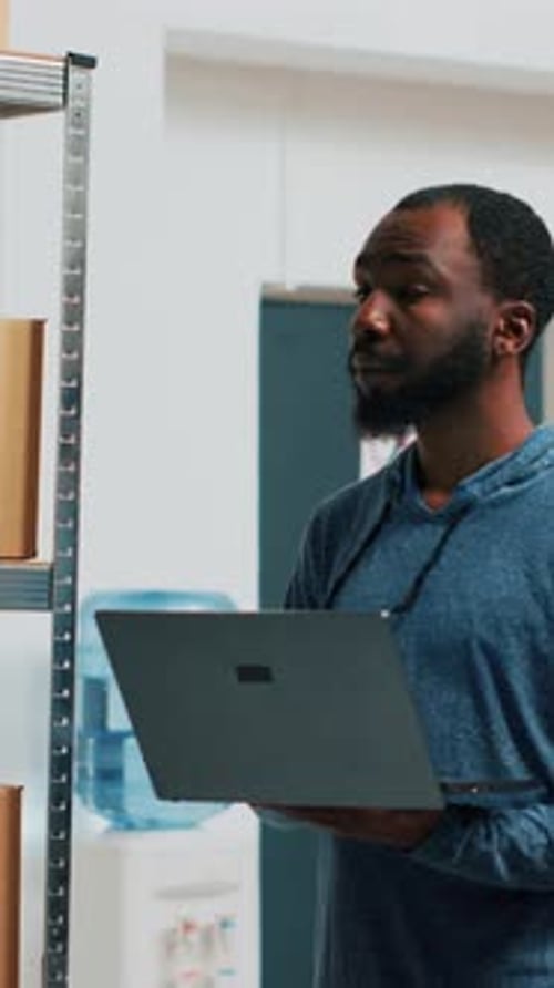Vertical Video Young Entrepreneur Doing Stock Inventory with Laptop
