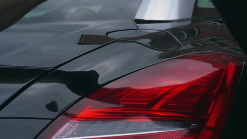 Hand Buffing Black Car Close Up