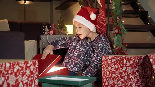 Excited Boy Opens Glowing Christmas Present