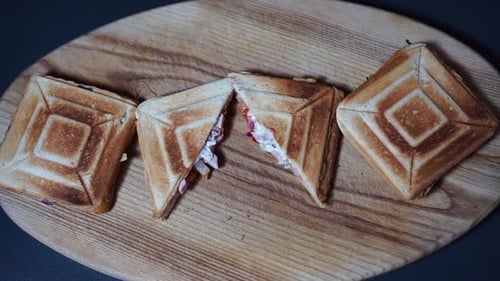 Grilled Sandwiches on Wooden Board with Knife