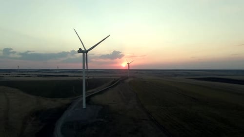Exploring Windmills at Sunset in a Windmill Park for Sustainable Electric Power Production