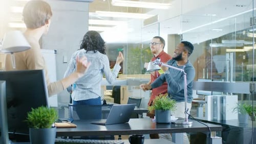 Diverse Group of Young Women and Men Dance and Have Fun in the Modern Office.
