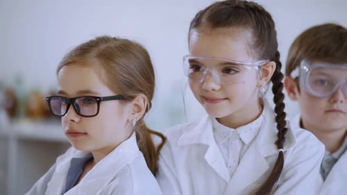 Young Students in Lab Coats and Safety Glasses
