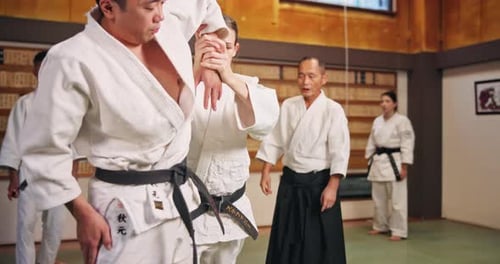 Woman Practicing Wrist Lock in Martial Arts Training