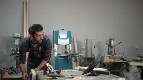 Carpenter is working at workshop.
