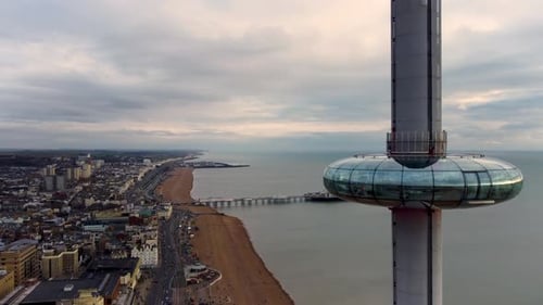 A 4K drone fly-past of the iconic Brighton i360 and beach below. You can see the passengers inside a
