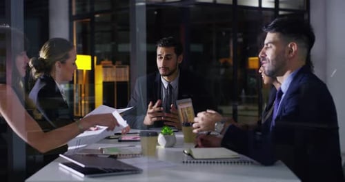 Office, documents and business people in meeting at night for planning, finance review and report