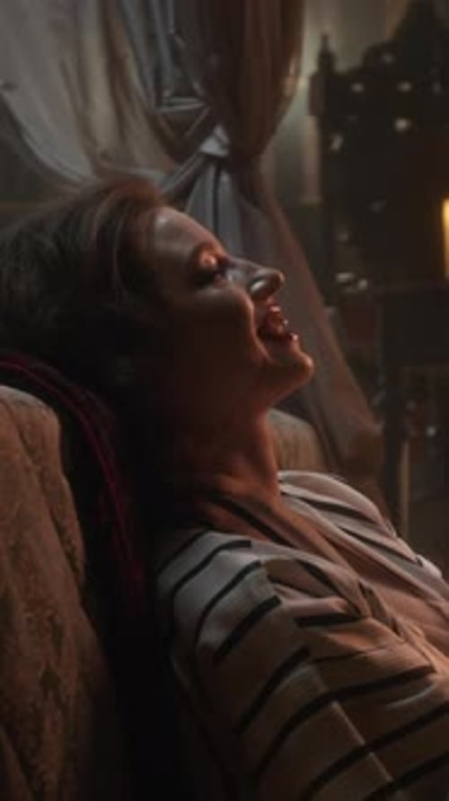 Smiling Vampire Woman Enjoying Small Glass of Blood