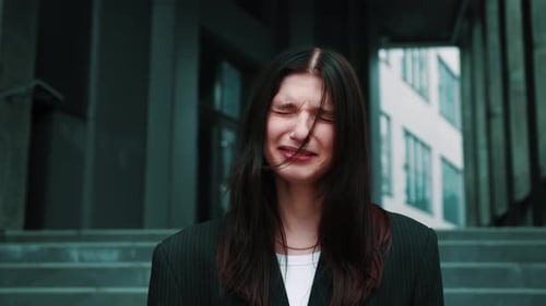 Sad and Depressed Adult Caucasian Beautiful Businesswoman Crying Outdoors Urban City