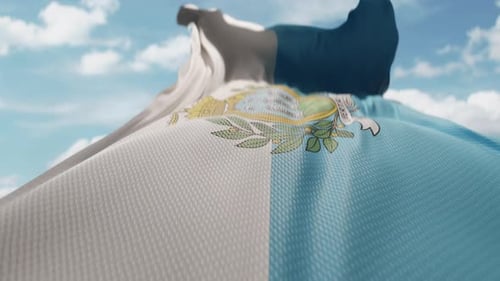 San Marino Flag Waving Against a Clear Blue Sky