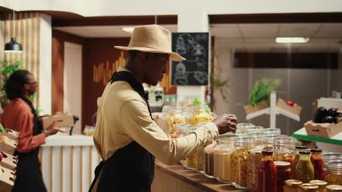 Local Farmer Arranging Eco Friendly Merchandise at Supermarket