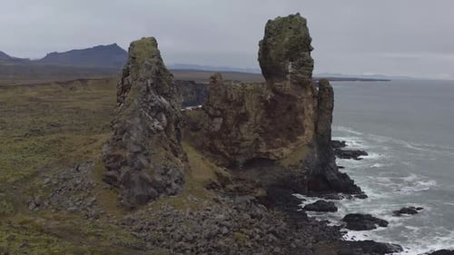 Flying around Londrangar, a pair of rock pillars on the coast of Snaefellsnes in Iceland.
