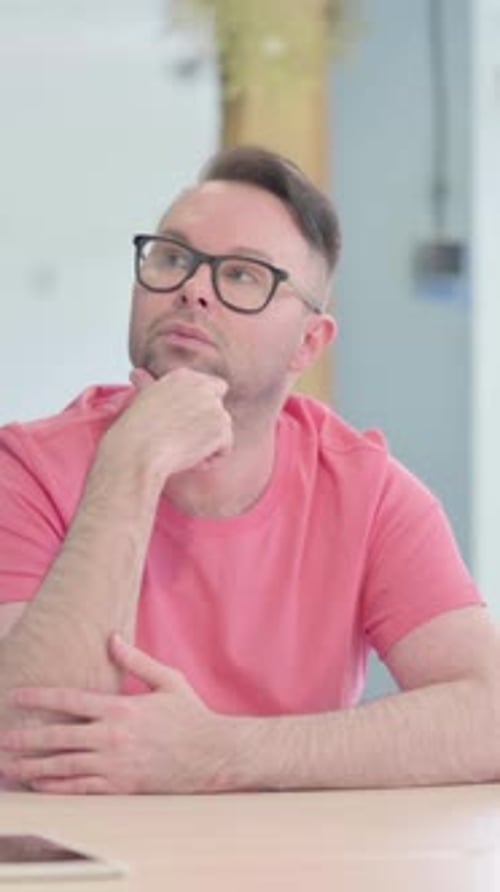 Man with Glasses Contemplating Serious Question