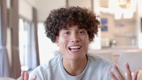 Man Smiling and Gesturing During Video Call