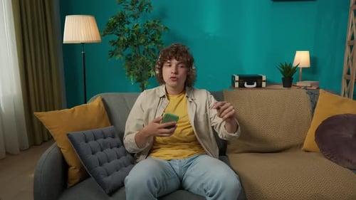 Enthusiastic Young Adult Listening to Music and Dancing