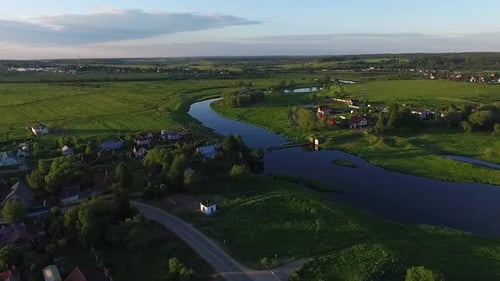 Behold an AweInspiring Aerial View of a Scenic River Flowing Through a Lush Green Landscape