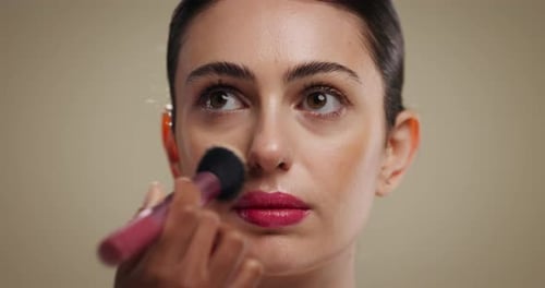 Woman, makeup brush and beauty in studio with foundation, self care and application on background