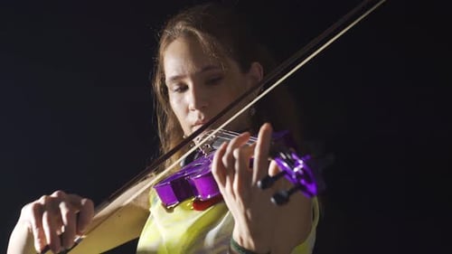 Woman Playing Purple Violin on Black Background