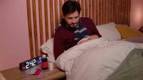 Ill Man in Bed Blowing His Nose