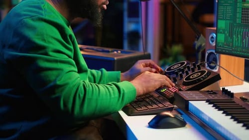Skilled Male Composer Producing New Songs on His Mixing Console