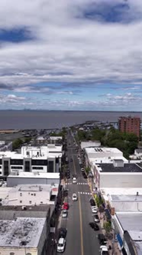 Aerial view of Atlantic Highlands, NJ, showing the coastal town street lined with buildings leading