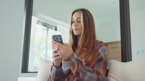 Young Woman Using Mobile Phone Indoors