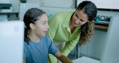 School Child with Teacher in STEM Computer Classroom Looking at Computer Code