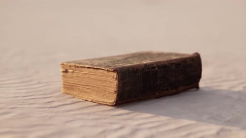 Old Book on the Sand Beach