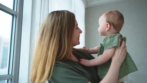 Loving Mother Holding her Adorable Baby