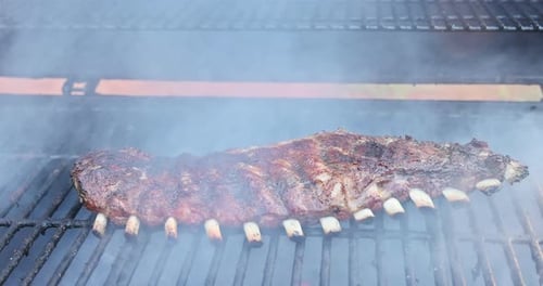 Marinated Pork Ribs are Being Roasted in BBQ Hot a Flaming Grill