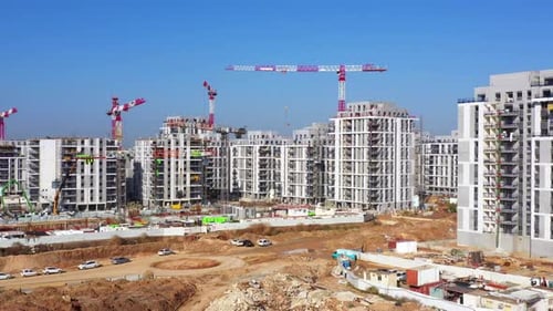 Residential Construction site with Cranes and building in progress, Aerial view.