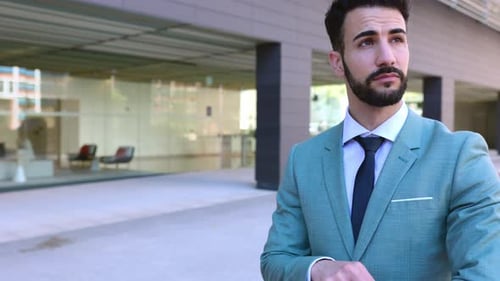 Man in Suit Checking Watch in Urban Setting