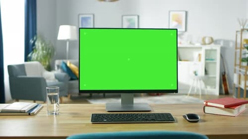 Zoom in On a Modern Personal Computer with Mock-up Green Screen Display Standing on the Desk of the