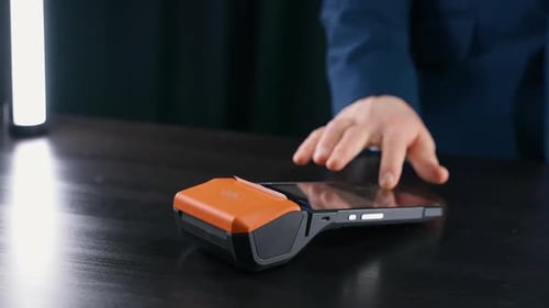 Woman Makes a Payment with Credit Card NFC Terminal Contactless Payment for Purchases