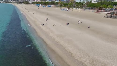 Aerial Video of a White Sandy Beach on a Sunny Day With Azure Waters and Gentle Waves on the